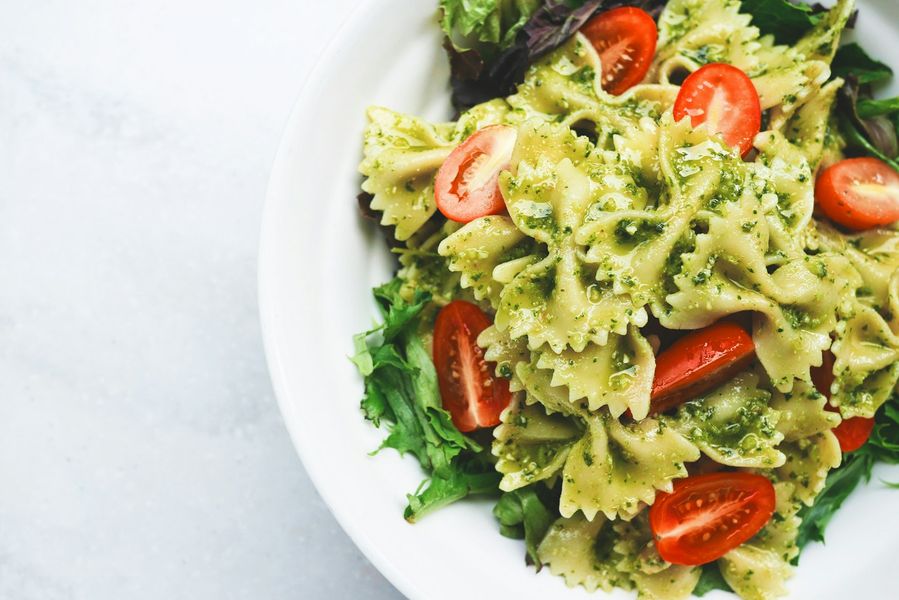Bowl of fresh farfalle with tomatoes and basil