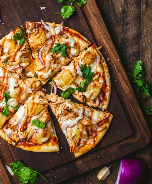 Wood-fired pizza on a serving board